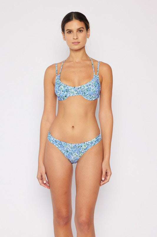 Blue and white floral bikini with double strap and structured top, worn by a woman from the front.