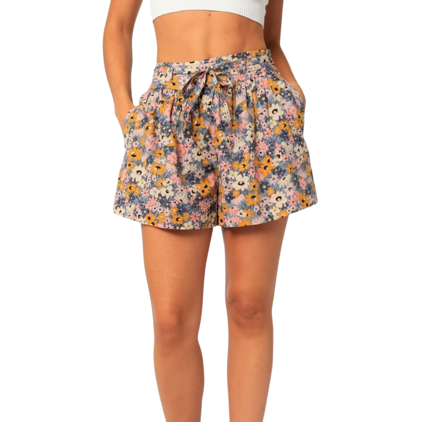 Colorful floral shorts with tie, worn by a woman from the front.