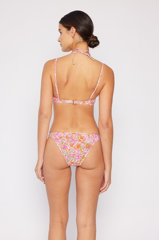 Pink, orange and white floral bikini with double strap and structured top, worn by a woman from the back.