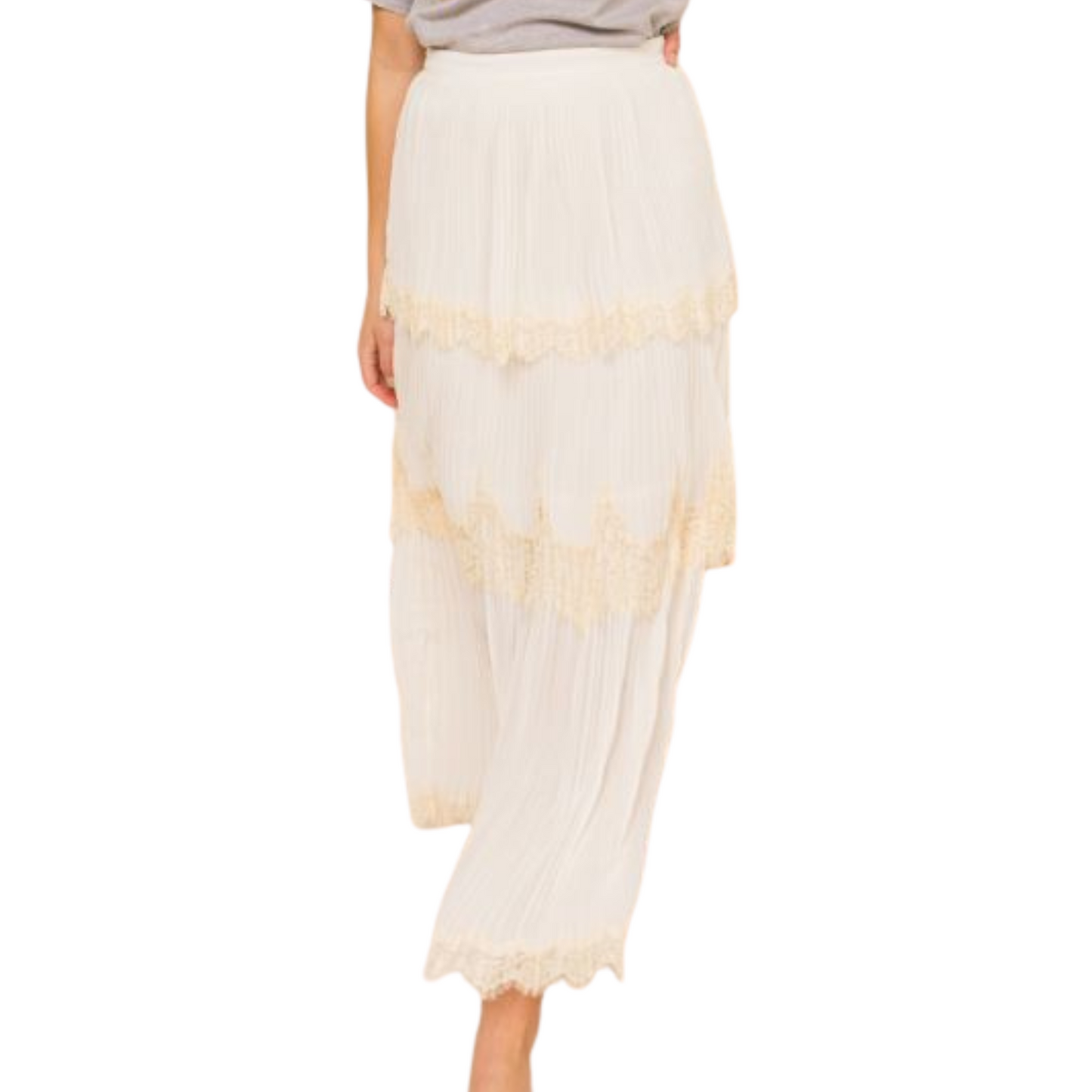 Maxi skirt with lace detailing, pleating, and a side zipper, worn by a woman from the front.