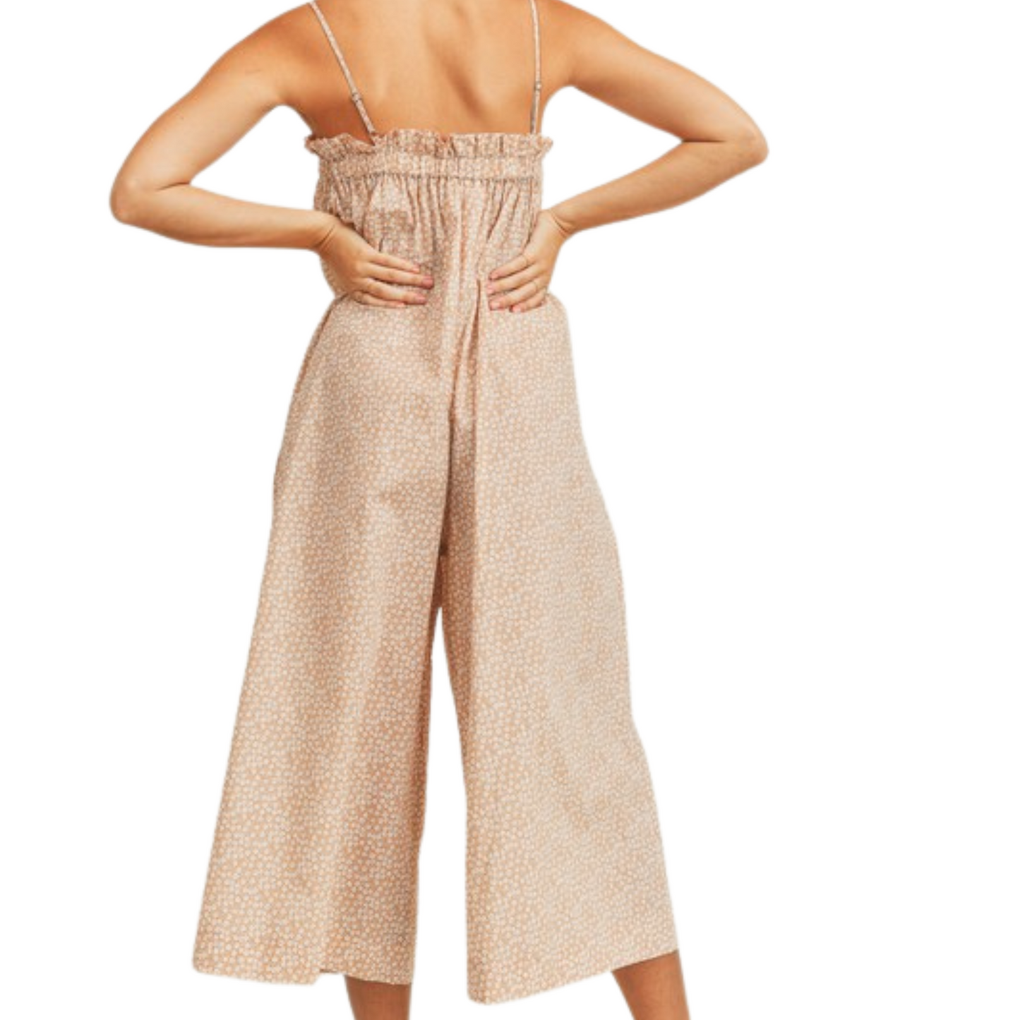 Peach floral jumpsuit with wide leg pants and pockets, worn by a woman from the back.