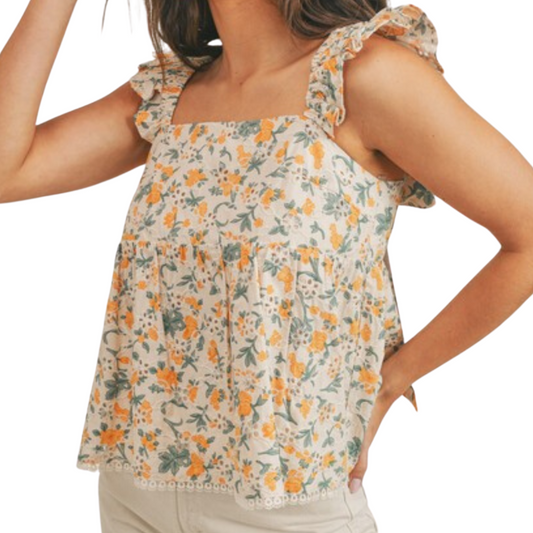 Orange and green babydoll style tank top with ruffle sleeves and tie back detail, worn by a woman from the front.