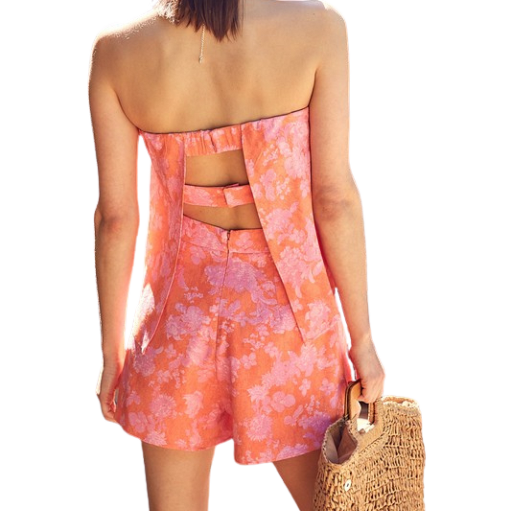 Orange and pink floral tube top romper with double-strapped, structured back, worn by a woman from the back.