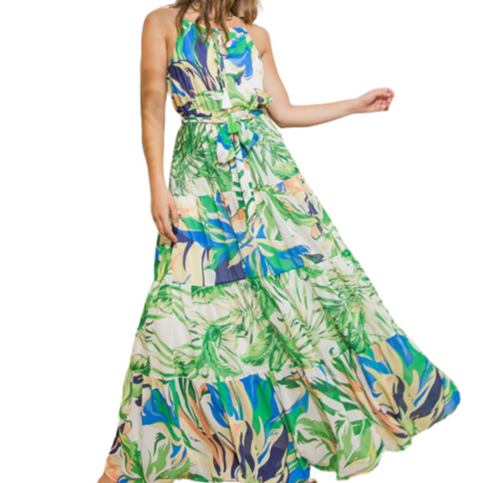 Multicolor, tropical print tiered maxi dress with tie, worn by a woman from the front.